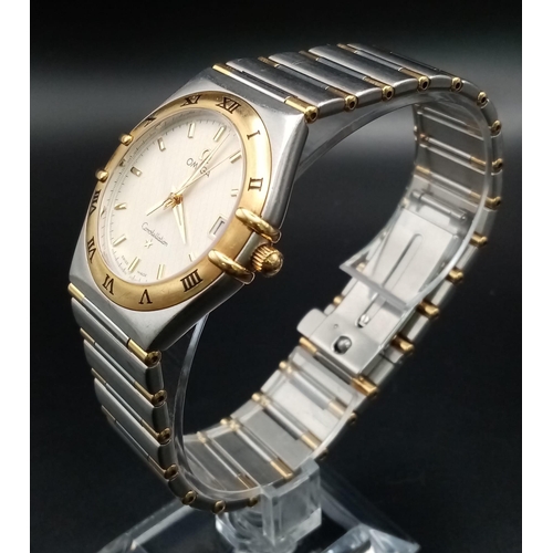 380 - An Omega Constellation Two Tone Gents Watch. Two tone strap and case - 33mm. Cream dial with date wi... 