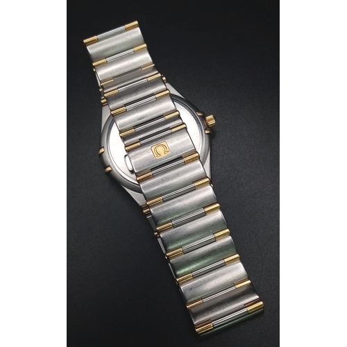 380 - An Omega Constellation Two Tone Gents Watch. Two tone strap and case - 33mm. Cream dial with date wi... 