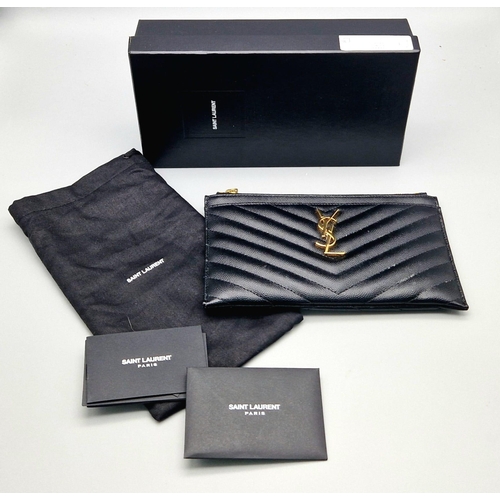 912 - A Yves Saint Laurent Black Leather Clutch Bag. Chevron design. Gilded YSL emblem. Dust cover and box... 