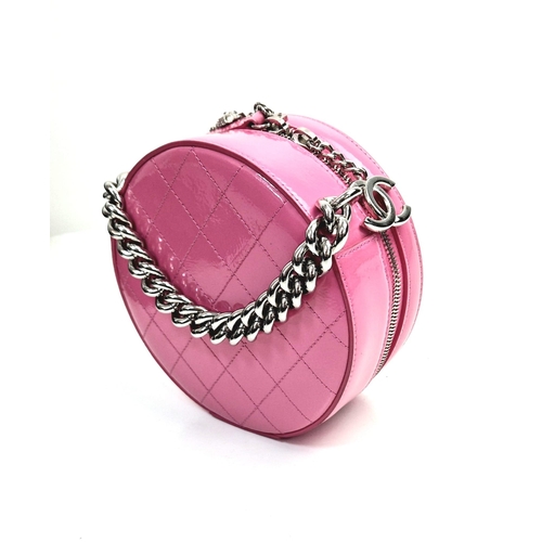 138 - A Chanel Round as Earth Patent Pink Leather Bag. Zipped closure. One interior pocket. Shoulder strap... 