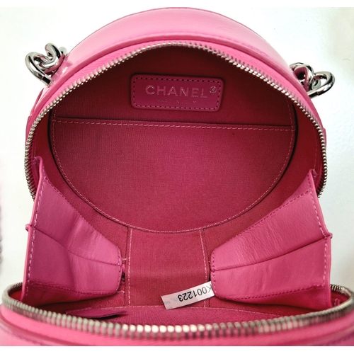 138 - A Chanel Round as Earth Patent Pink Leather Bag. Zipped closure. One interior pocket. Shoulder strap... 