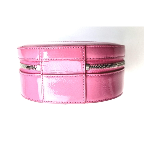 138 - A Chanel Round as Earth Patent Pink Leather Bag. Zipped closure. One interior pocket. Shoulder strap... 