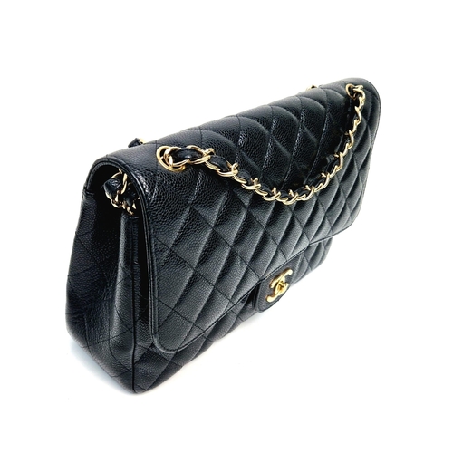 14 - A Classic Chanel Jumbo Flap Bag. Quilted caviar black calfskin. Double flaps. Interior zipped pocket... 