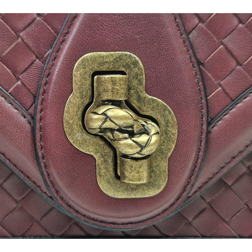 20 - A Bottega Veneta City Knot Bag. Burgundy lambskin leather. Flap closure. Two interior compartments. ... 