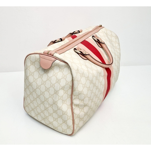 233 - A Gucci Boston Bag. Monogram canvas in a light beige hue. Pink leather trim and handles. Gilded hard... 