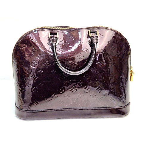 317 - A Louis Vuitton Amarante Alma Vernis Handbag. Patent purple monogram leather. Gilded zip and padlock... 