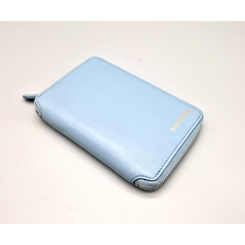 445 - A Balenciaga Blue Leather Wallet. Black leather exterior. Dust cover. In good condition but please s... 