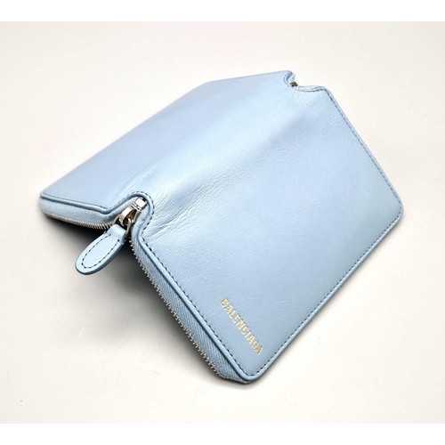 445 - A Balenciaga Blue Leather Wallet. Black leather exterior. Dust cover. In good condition but please s... 