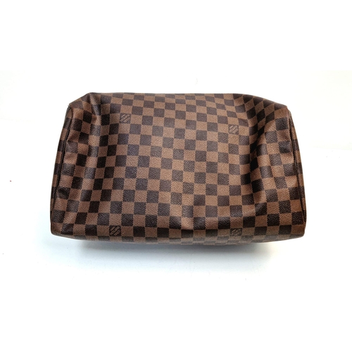 534 - A Louis Vuitton Speedy Bag. Monogram brown canvas. Brown leather handles. Plush red cloth interior. ... 