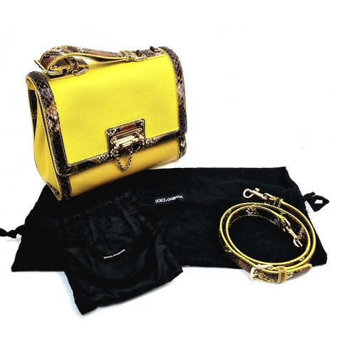 552 - A Dolce and Gabbana Monica Bag. Yellow leather and python exterior. Flap closure. Gilded hardware. O... 