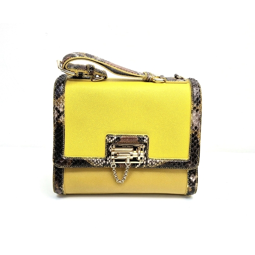 552 - A Dolce and Gabbana Monica Bag. Yellow leather and python exterior. Flap closure. Gilded hardware. O... 