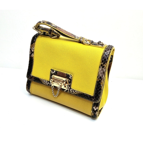 552 - A Dolce and Gabbana Monica Bag. Yellow leather and python exterior. Flap closure. Gilded hardware. O... 