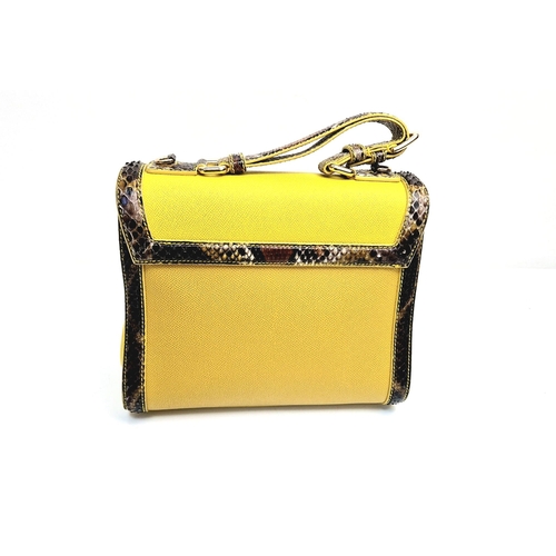 552 - A Dolce and Gabbana Monica Bag. Yellow leather and python exterior. Flap closure. Gilded hardware. O... 