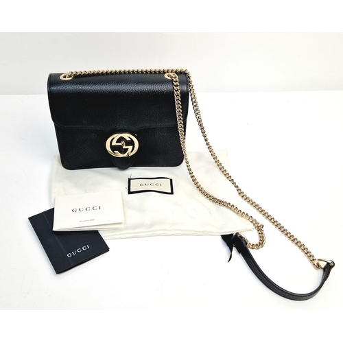 566 - A Gucci Interlocking Black Leather Small Shoulder Bag. Pebbled calfskin with gilded hardware. Spacio... 