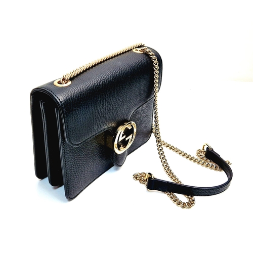 566 - A Gucci Interlocking Black Leather Small Shoulder Bag. Pebbled calfskin with gilded hardware. Spacio... 