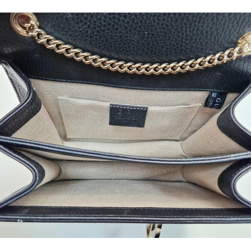 566 - A Gucci Interlocking Black Leather Small Shoulder Bag. Pebbled calfskin with gilded hardware. Spacio... 