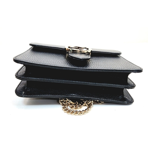 566 - A Gucci Interlocking Black Leather Small Shoulder Bag. Pebbled calfskin with gilded hardware. Spacio... 