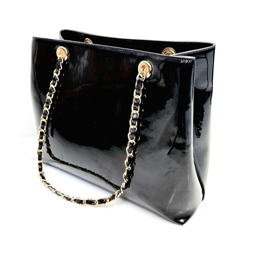 729 - A Valentino Patent Black Tote Bag. Gilded hardware. Zipped inner compartment. Embossed logo. 36cm wi... 