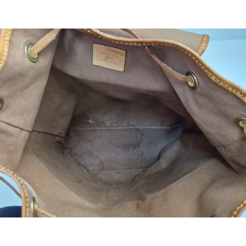 738 - A Louis Vuitton Backpack. Monogram brown canvas. Leather trim. Zipped exterior pockets. Thick cloth ... 