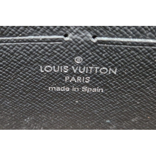 859 - A Louis Vuitton Clutch Wallet with Handle. Brown monogram canvas. Silver-tone hardware. Zipped inter... 