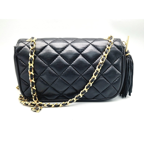 884 - A Givenchy Black Quilted Leather Flap Handbag. Gold-tone hardware. Zipped interior pocket. Please se... 