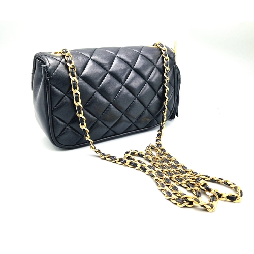 884 - A Givenchy Black Quilted Leather Flap Handbag. Gold-tone hardware. Zipped interior pocket. Please se... 