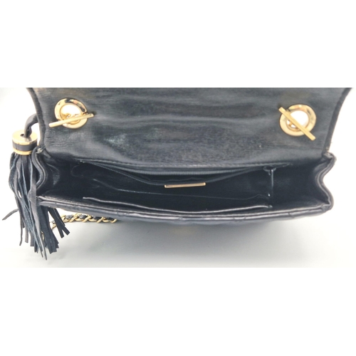 884 - A Givenchy Black Quilted Leather Flap Handbag. Gold-tone hardware. Zipped interior pocket. Please se... 