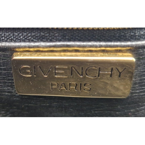 884 - A Givenchy Black Quilted Leather Flap Handbag. Gold-tone hardware. Zipped interior pocket. Please se... 