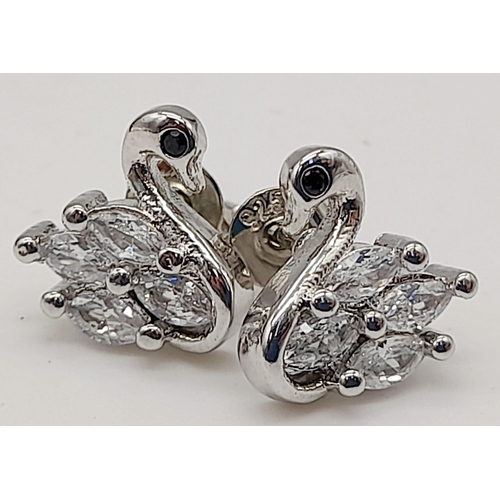 1104 - Three Pairs of 925 Silver Earrings. Swan stud, Floral stud and Moonstone drop.