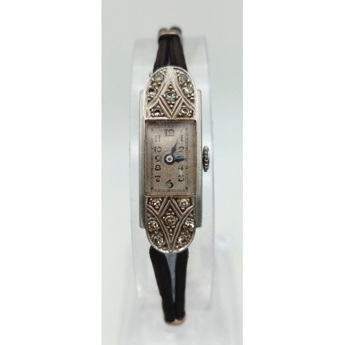 1186 - A Vintage Art Deco Style Platinum and Diamond Ladies Watch. Rectangular case - 11 x 30mm. Rope-style... 