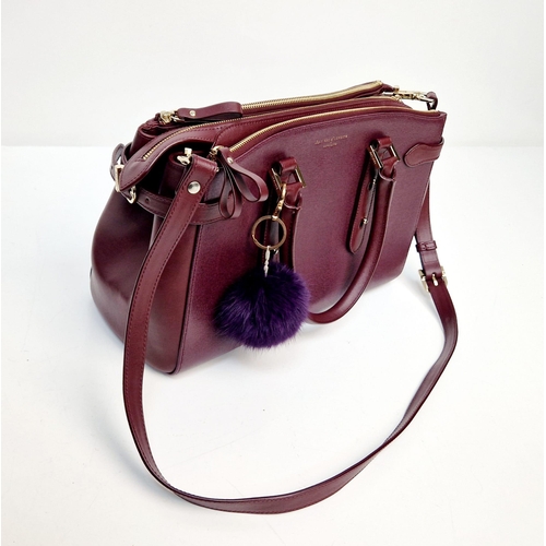 117 - An Aspinal of London Burgundy Leather Hand/Shoulder Bag. Gold-tone hardware. Three zipped openings l... 