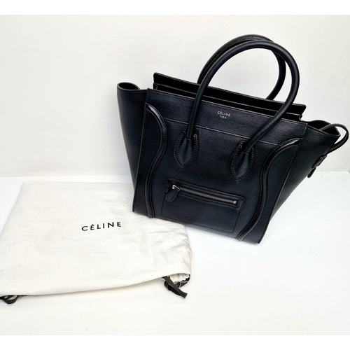 611 - A Celine of Paris Micro Luggage Handbag in Black Leather. Zipped exterior and interior pockets. Spac... 