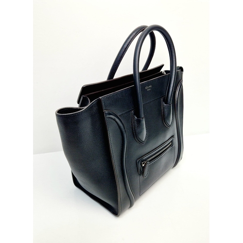 611 - A Celine of Paris Micro Luggage Handbag in Black Leather. Zipped exterior and interior pockets. Spac... 