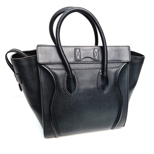 611 - A Celine of Paris Micro Luggage Handbag in Black Leather. Zipped exterior and interior pockets. Spac... 