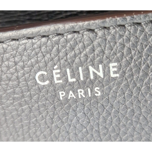 611 - A Celine of Paris Micro Luggage Handbag in Black Leather. Zipped exterior and interior pockets. Spac... 