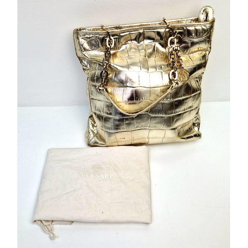 880 - A Metallic Faux Leather Versace Tote Bag. Gold-tone hardware. Dual handles. Spacious interior with z... 