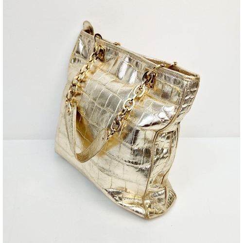 880 - A Metallic Faux Leather Versace Tote Bag. Gold-tone hardware. Dual handles. Spacious interior with z... 