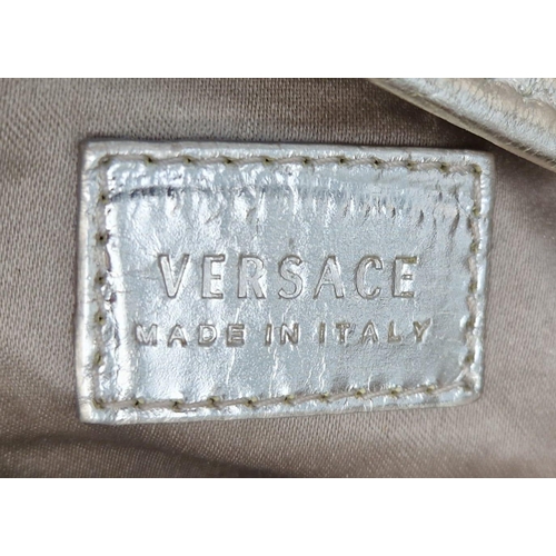 880 - A Metallic Faux Leather Versace Tote Bag. Gold-tone hardware. Dual handles. Spacious interior with z... 