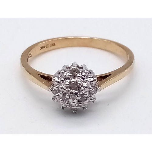 410 - 9K YELLOW GOLD DIAMOND CLUSTER RING.  0.10CT DIAMOND. TOTAL WEIGHT 2G.  SIZE N