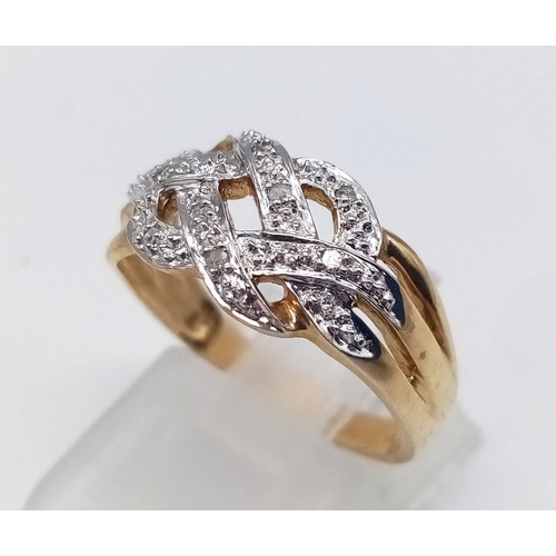 592 - 9K YELLOW GOLD DIAMOND CELTIC STYLE RING. TOTAL WEIGHT 2.7G.  SIZE M