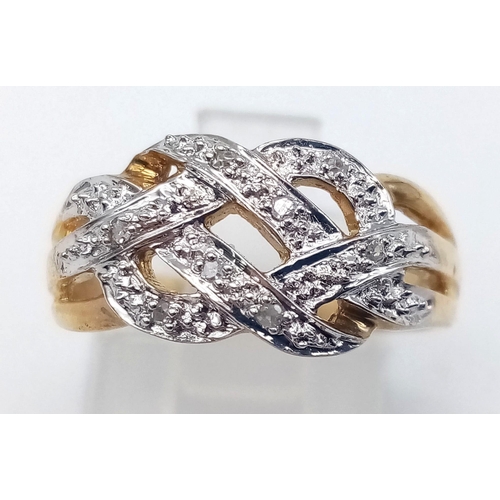 592 - 9K YELLOW GOLD DIAMOND CELTIC STYLE RING. TOTAL WEIGHT 2.7G.  SIZE M