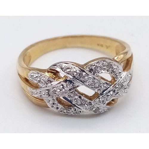 592 - 9K YELLOW GOLD DIAMOND CELTIC STYLE RING. TOTAL WEIGHT 2.7G.  SIZE M