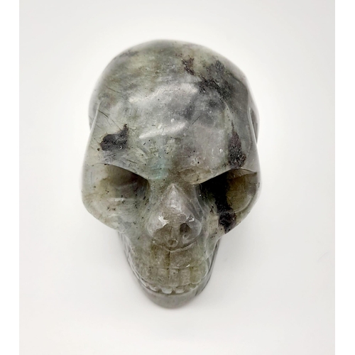 891 - A Menacing Grabbo Jasper Skull Figure. 5 x 4cm.