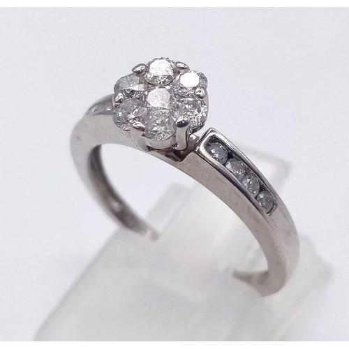 90 - 18K WHITE GOLD DIAMOND FLOWER CLUSTER RING WITH DIAMOND SET SHOULDERS. 0.50CT DIAMOND. TOTAL WEIGHT ... 