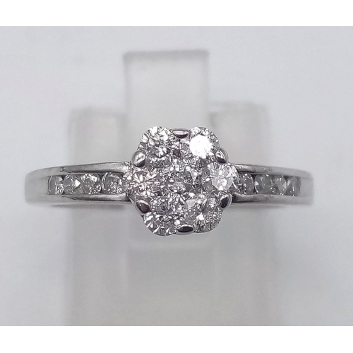 90 - 18K WHITE GOLD DIAMOND FLOWER CLUSTER RING WITH DIAMOND SET SHOULDERS. 0.50CT DIAMOND. TOTAL WEIGHT ... 