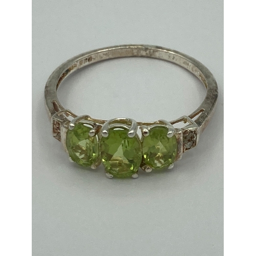 159 - Stunning vintage PERIDOT and DIAMOND RING mounted to top and set in a SILVER BAND. Complete with rin... 