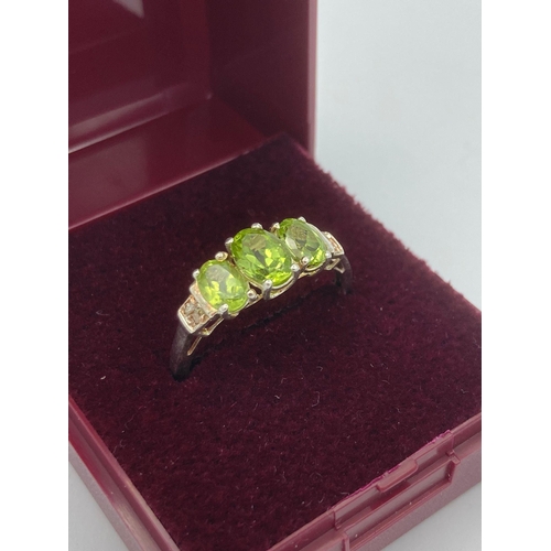 159 - Stunning vintage PERIDOT and DIAMOND RING mounted to top and set in a SILVER BAND. Complete with rin... 