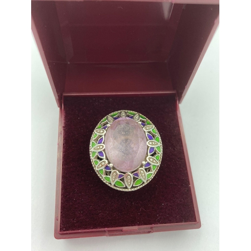 194 - SILVER and AMETHYST STATEMENT RING having an enormous oval cut Amethyst set to top with green and pu... 