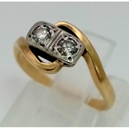 563 - 18K YELLOW GOLD & PLATINUM VINTAGE 2 DIAMOND CROSSOVER RING. TOTAL WEIGHT 2.5G.  0.10CT DIAMOND. SIZ... 