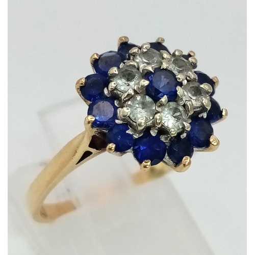 115 - 9K YELLOW GOLD VINTAGE WHITE AND BLUE STONE CLUSTER RING. TOTAL WEIGHT 3.8G.  SIZE O